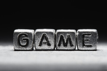 Conceptual inscription game on metal cubes on a black gray background close-up isolated
