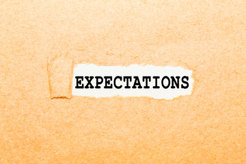 a text EXPECTATIONS on a torn piece of paper, a business concept