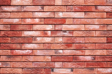 A wall of red-brown brick, texture, background.