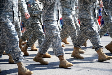 USA army marching band in a parade outdoors.