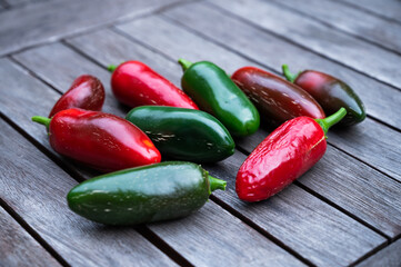 home-grown peppers lie harvested on a rustic wooden table as a concept for urban gardening
