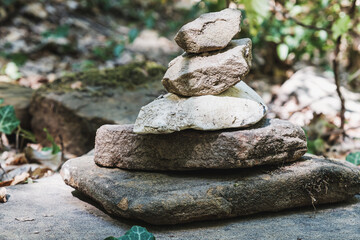 zen stone stack with balanced stones on stones in equilibrium, pile of rocks in the woods