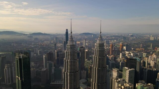 Aerial view flight upward of Kuala Lumpur City Center in the morning. 