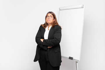  shrugging, feeling confused and uncertain, doubting with arms crossed and puzzled look