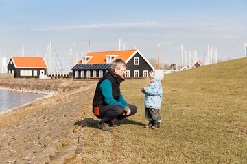 Mature man with toddler girl on dyke