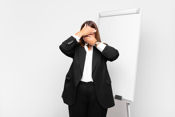  covering face with both hands saying no to the camera! refusing pictures or forbidding photos
