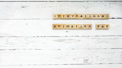 international animation day. square cubes with letters.