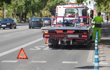 Warning foldable triangle placed before tow track