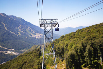 Mountain lift cab moves, transport to the top to the sky, clouds