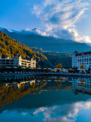 Reflection of the Krasnaya Polyana mountains (Sochi, Russia) in a pond in autumn