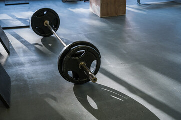 Obraz na płótnie Canvas Barbell on the floor in the gym