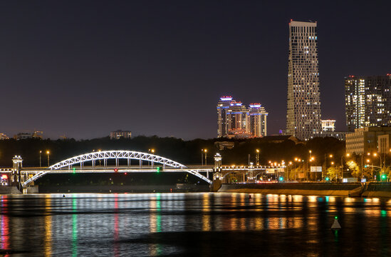 night city with skyscrapers and a bridge over the river with lights reflected in the water. megapolis Moscow