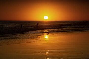 Lovely Orange  sunset with sun at the horizon at Claromeco beach