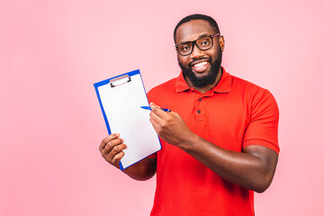 Young african american inspector man wearing glasses holding clipboard checklist with surprise face isolated over pink background.