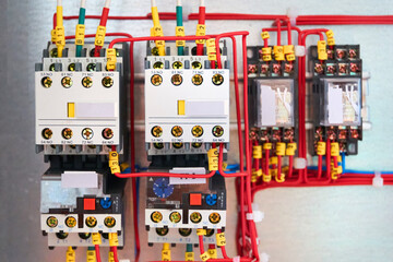 Obraz na płótnie Canvas Electrical relays with connected wires. Industrial background.