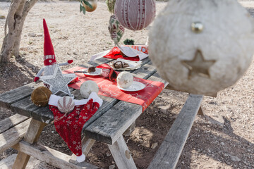 A Christmas decorated picnic table
