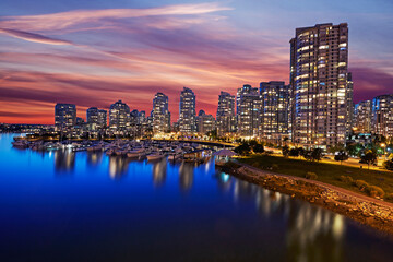 Skyline of apartments in Vancouver with red sunset sky at dusk