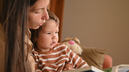 Obraz na płótnie Canvas mom and child read a book before bedtime child