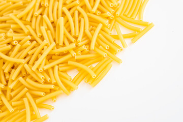 Raw dry uncooked Macaroni pasta spaghetti noodle on white bowl wooden background for basil tomato pesto sauce Homemade Italian food organic whole wheat vegan spaghetti for a healthy meal