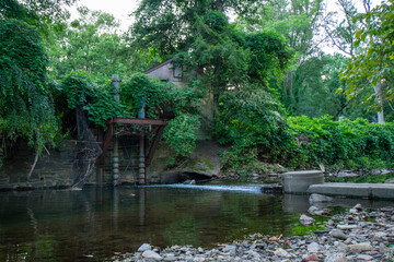 Fototapeta na wymiar A Small Abandoned Dam in a Creek in Elkins Park, Pennsylvania