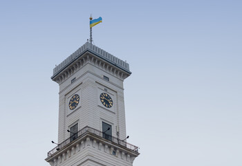 Fototapeta na wymiar town hall with flag on sky background