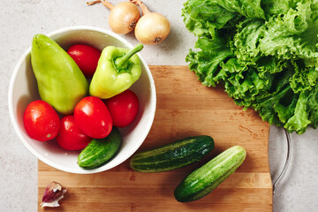 Fresh vegetables on a cutting board, salad ingredients.