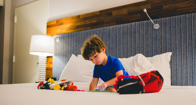 child painting a hotel room on a bed stock photo royalty free 