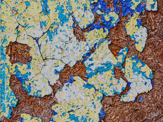 Textured wood surface covered with old peeling paint.