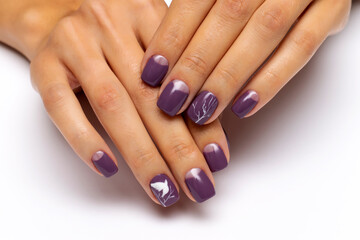 Obraz na płótnie Canvas Gel autumn nail design. Purple moon manicure with painted white doves on the nails and white wood with silver on short square nails.
