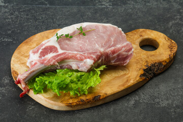Raw pork bone steak over wooden