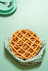 Homemade apple tart on a green table. Delicious apple pie with a lattice crust.