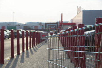 Metal supermarket trolley in the parking lot near the shopping mall © svitlini