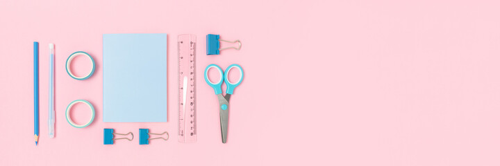 Group of blue stationery on a pink pastel background. Banner with place for text.