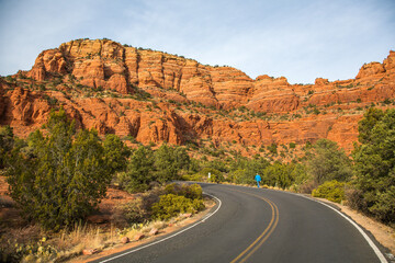 A man walking on the road leading to the Chapel of the Holy Cross, a Roman Catholic chapel built into the buttes near Sedona, Arizona.  