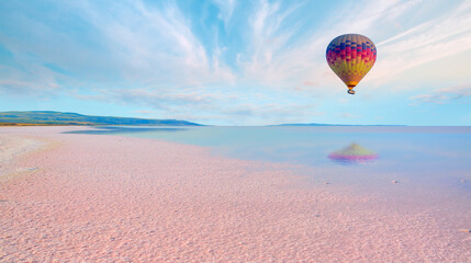 Hot air balloon flying over pink salt lake - Ankara, Turkey