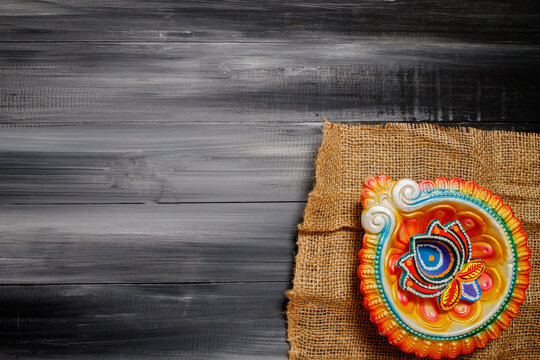 Happy Diwali Greeting Card made using sweets, or fire crackers or Diya or flowers.