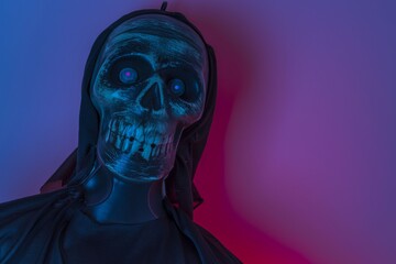 For halloween  celebration look of black illuminated skeleton head on blue and red background.
