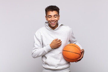 young man laughing out loud at some hilarious joke, feeling happy and cheerful, having fun. basket concept