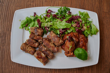 Grilled meat with green vegetables on wooden table