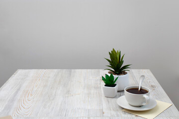 Office desk wood table of Business work place, artificial plants and coffee cup