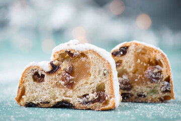 Christ stollen, traditonal christmas cake with nuts, raisons, marzipan on a blue bakcground, empty...