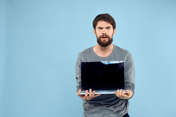 Bearded man laptop in hand internet wireless technology emotions blue background