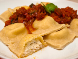 Cheese ravioli with tomato sauce and basil