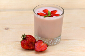 glass of fruit yogurt and strawberries close up