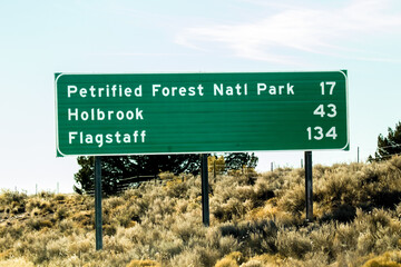 A state highy sign showing distances to Flagstaff, Holbrook and Petrified Forest National Park,...