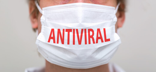 Antiviral Coronavirus theme with person wearing a protective surgical face mask