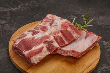 Raw pork ribs served rosemary