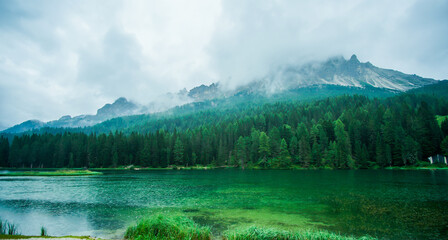 A rainy and foggy day by the green lake and mountains