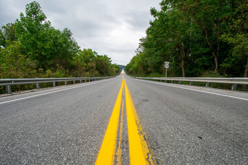 A Shot From the Center of a Road With a Large Long Bridge Up Ahead
