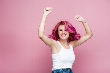 young woman with colorful hair rejoicing isolated on pink